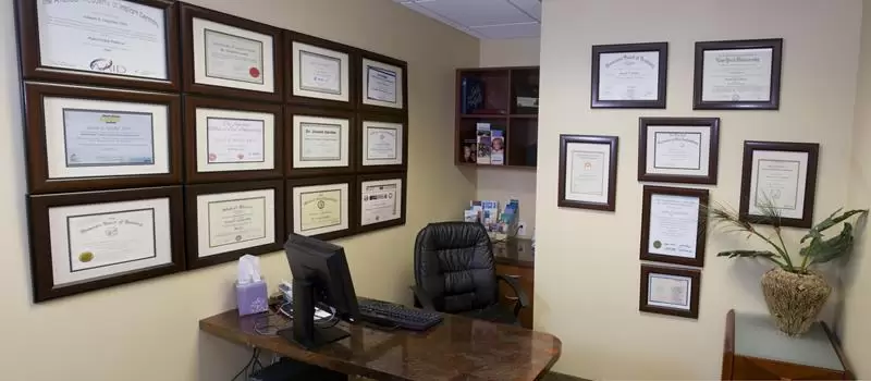 Dr. Gendler’s credentials wall at Gendler Dental Center