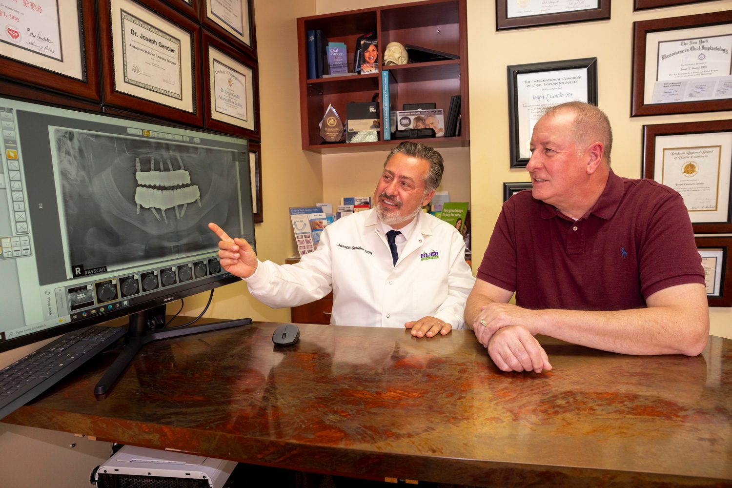 Dr. Gendler reviews a dental scan with a patient at Gendler Dental Center