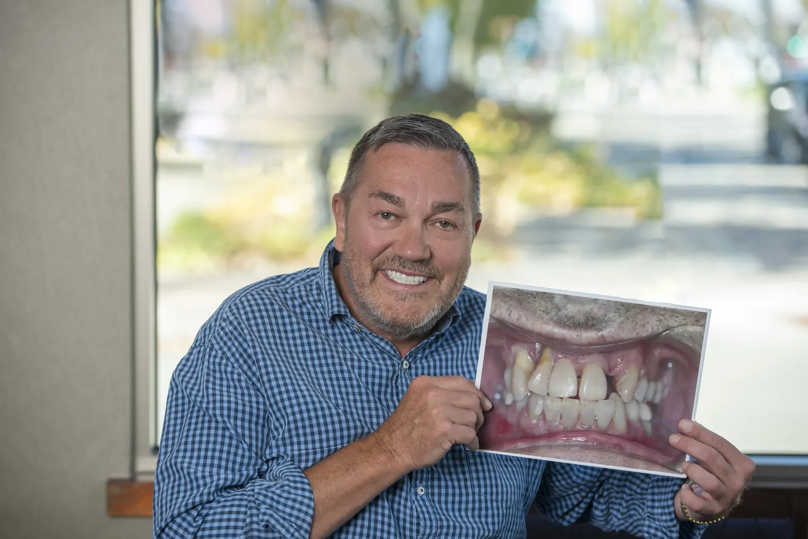 A smiling dental patient at Gendler Dental Center.