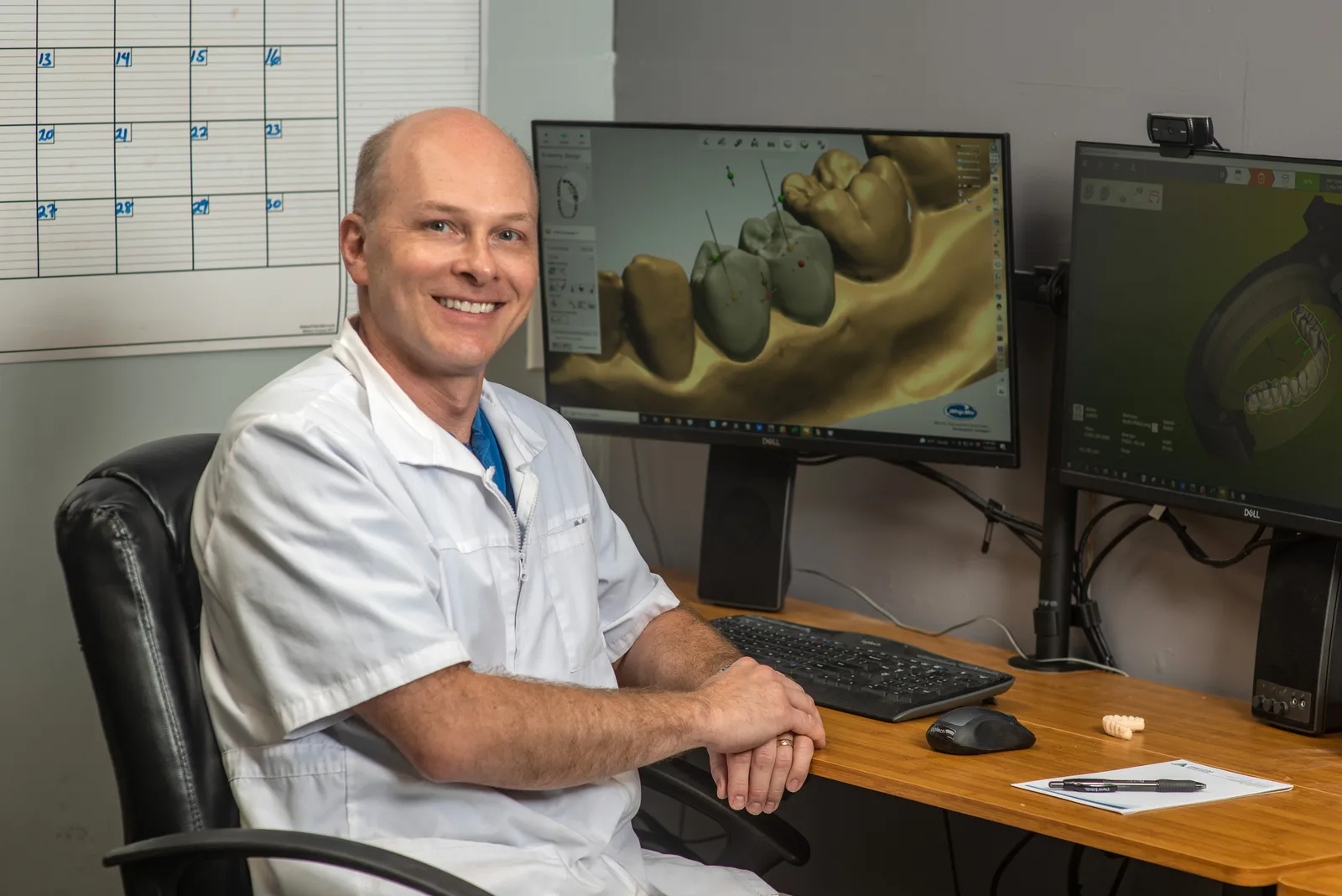 Lab tech doing same-day repair on a denture or prosthetic.