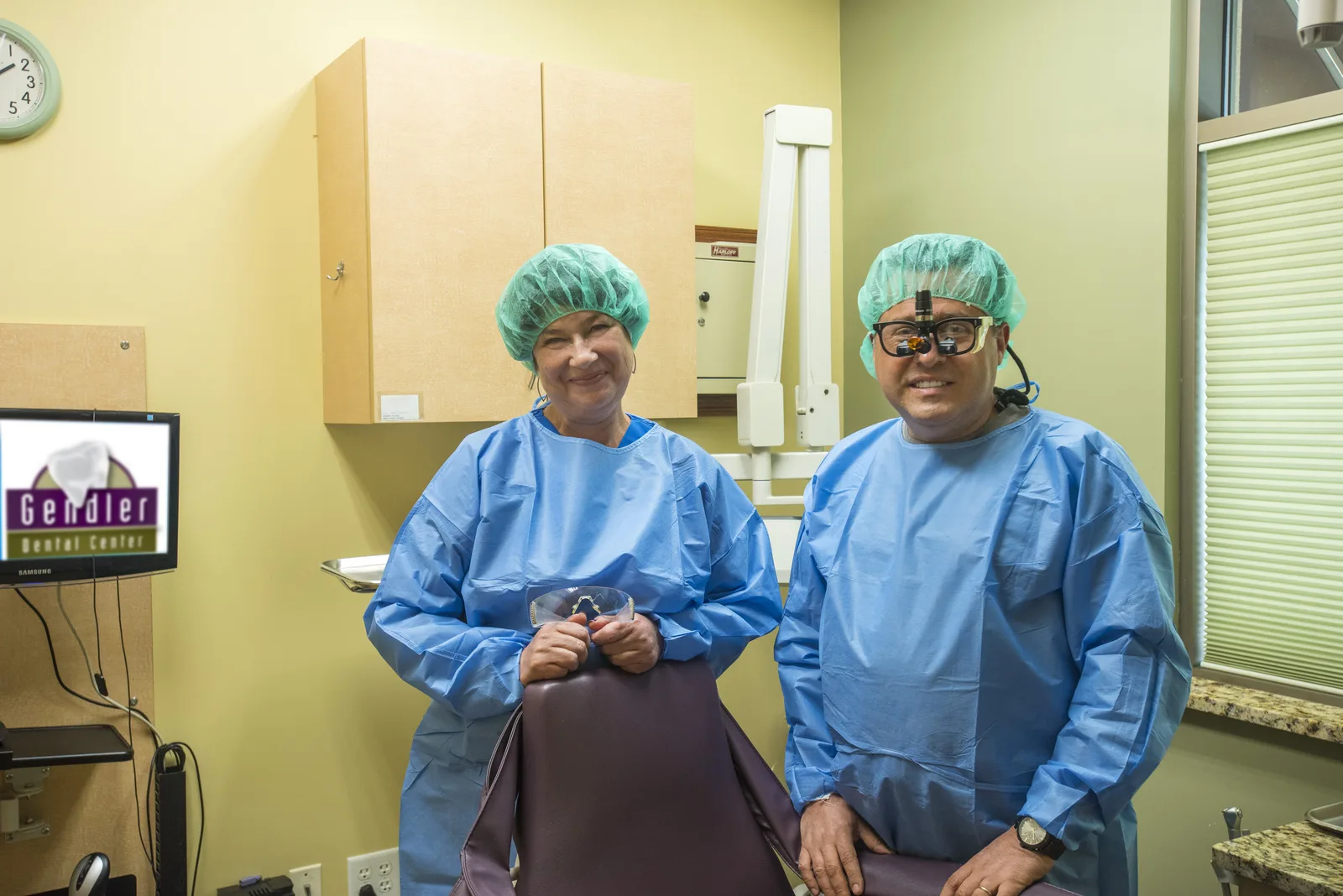Dr. Gendler and a surgical assistant gowned for implant surgery